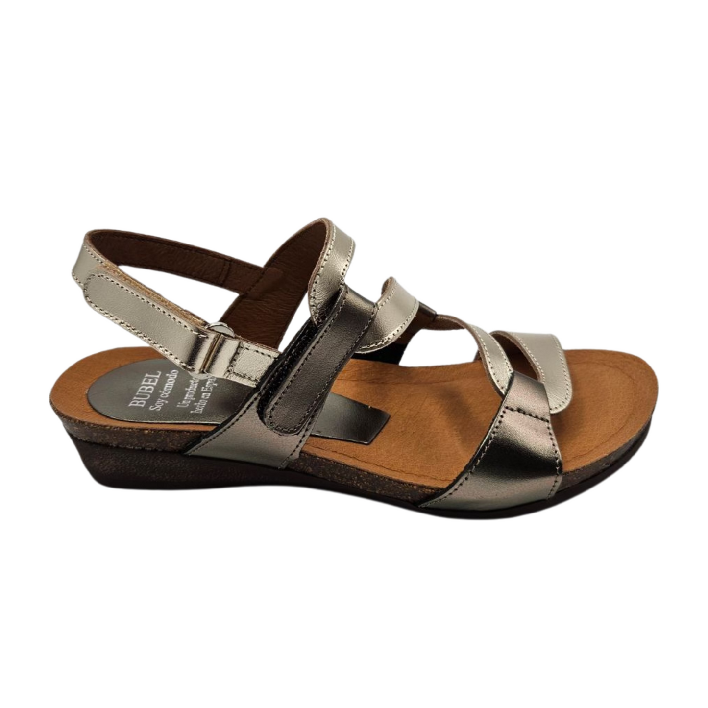 Right facing  view of metallic leather sandal with wavy strap design, rounded toe and slight wedge heel.