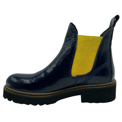 Left facing view navy patent leather ankle boot with yellow elastic side gore and black lug sole