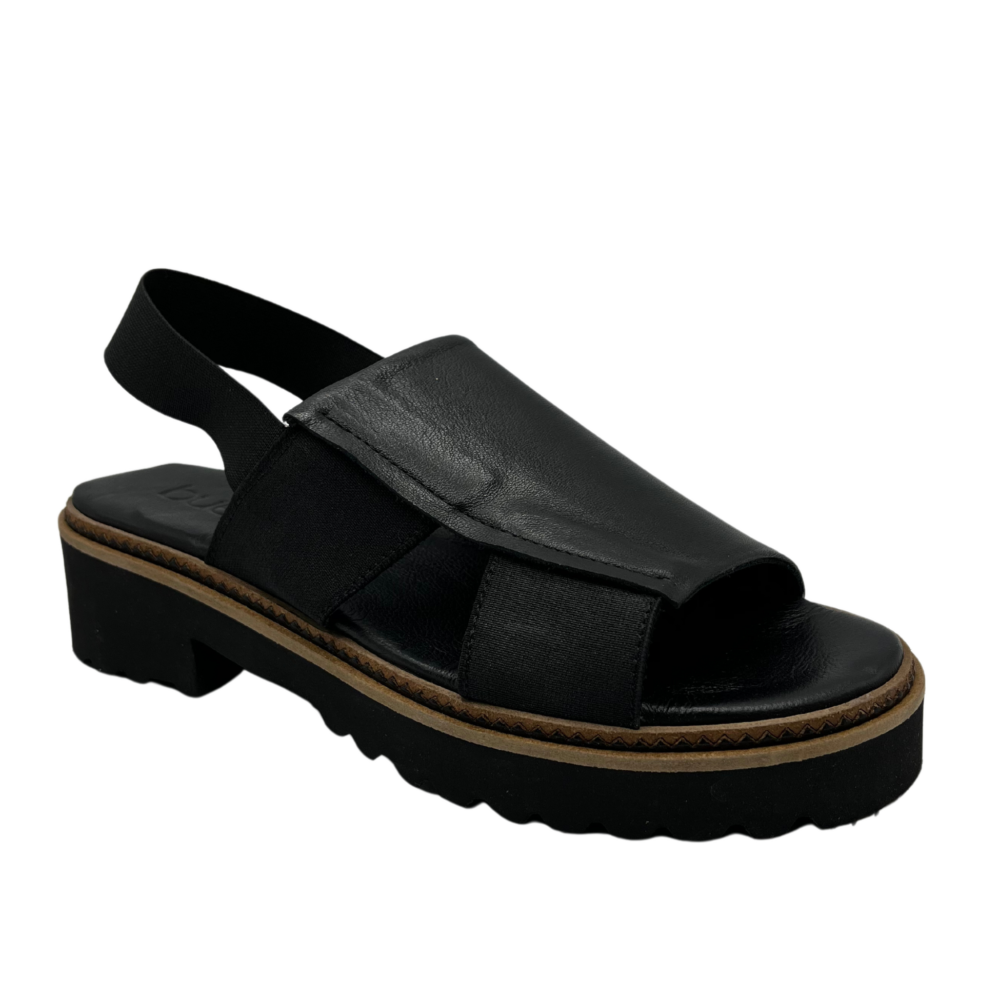 45 degree angled view of black slip on sandal with chunky black sole
