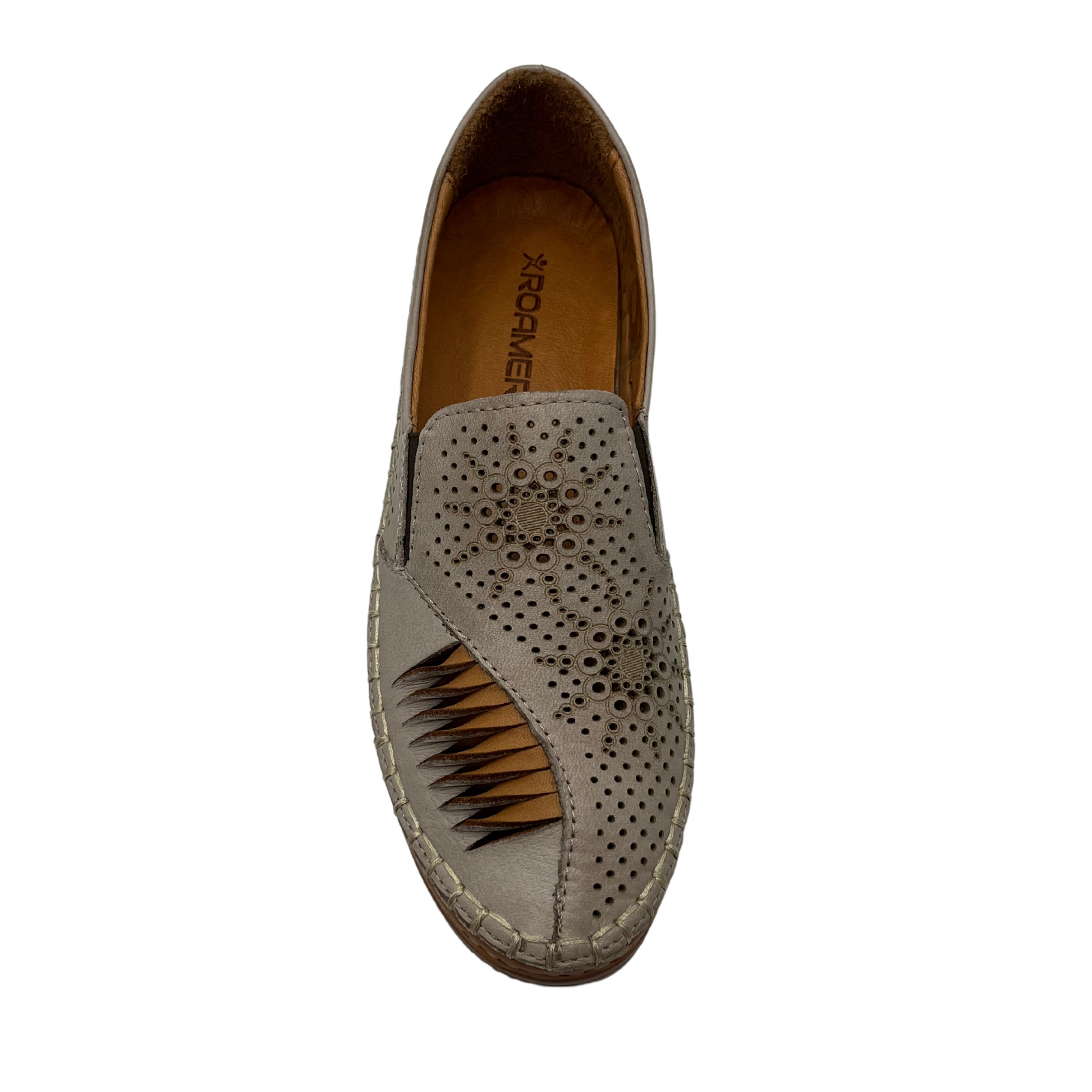 Top view of off white shoe with embossed details with inner brown lining