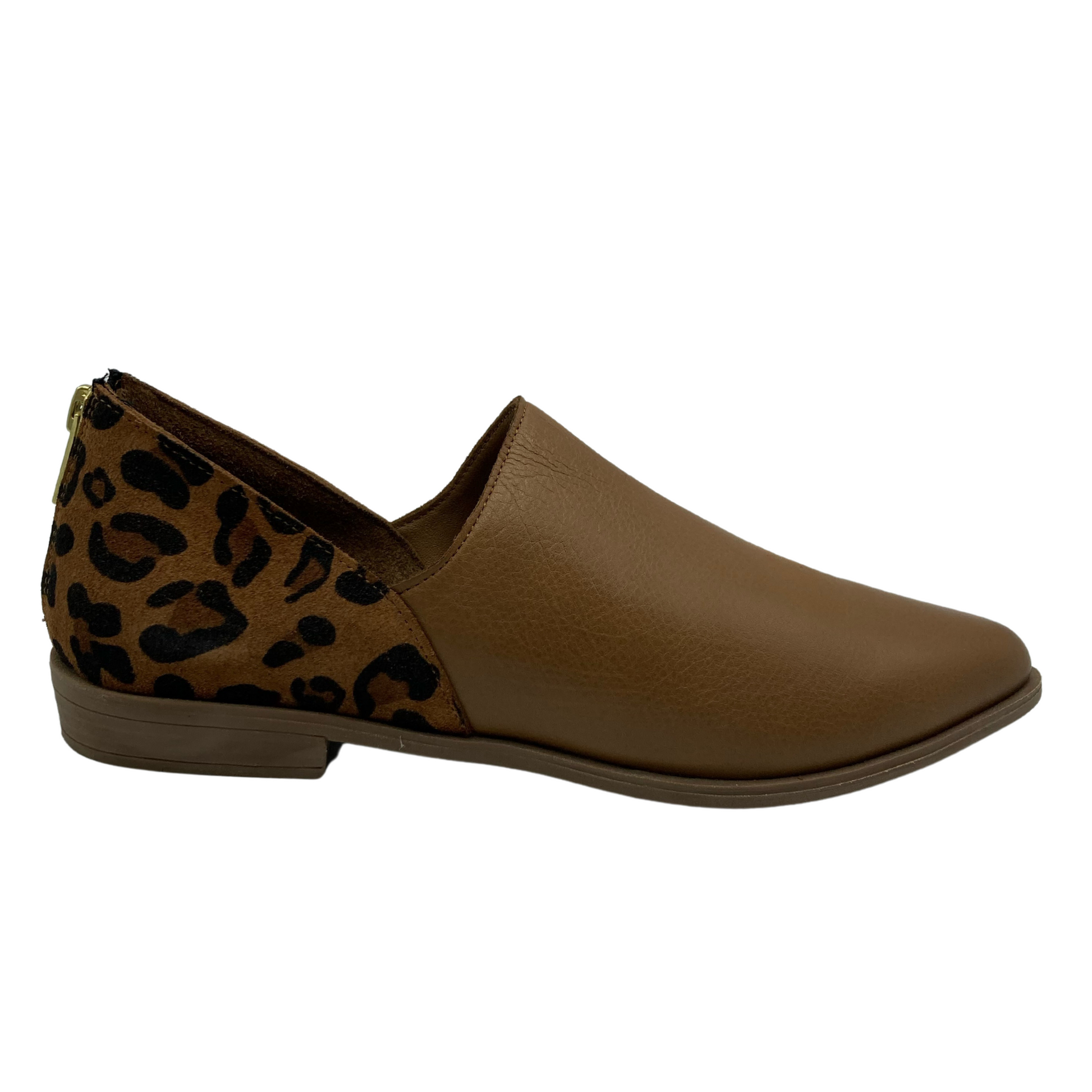 Side view of brown pointed toe shoe with low heel