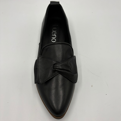 Top view of a black leather loafer with a bow accent on the toe box