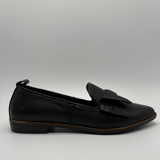 Right facing view of a black leather loafer with a bow accent on the toe box