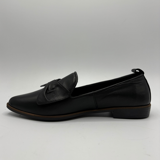 Left facing view of a black leather loafer with a bow accent on the toe box