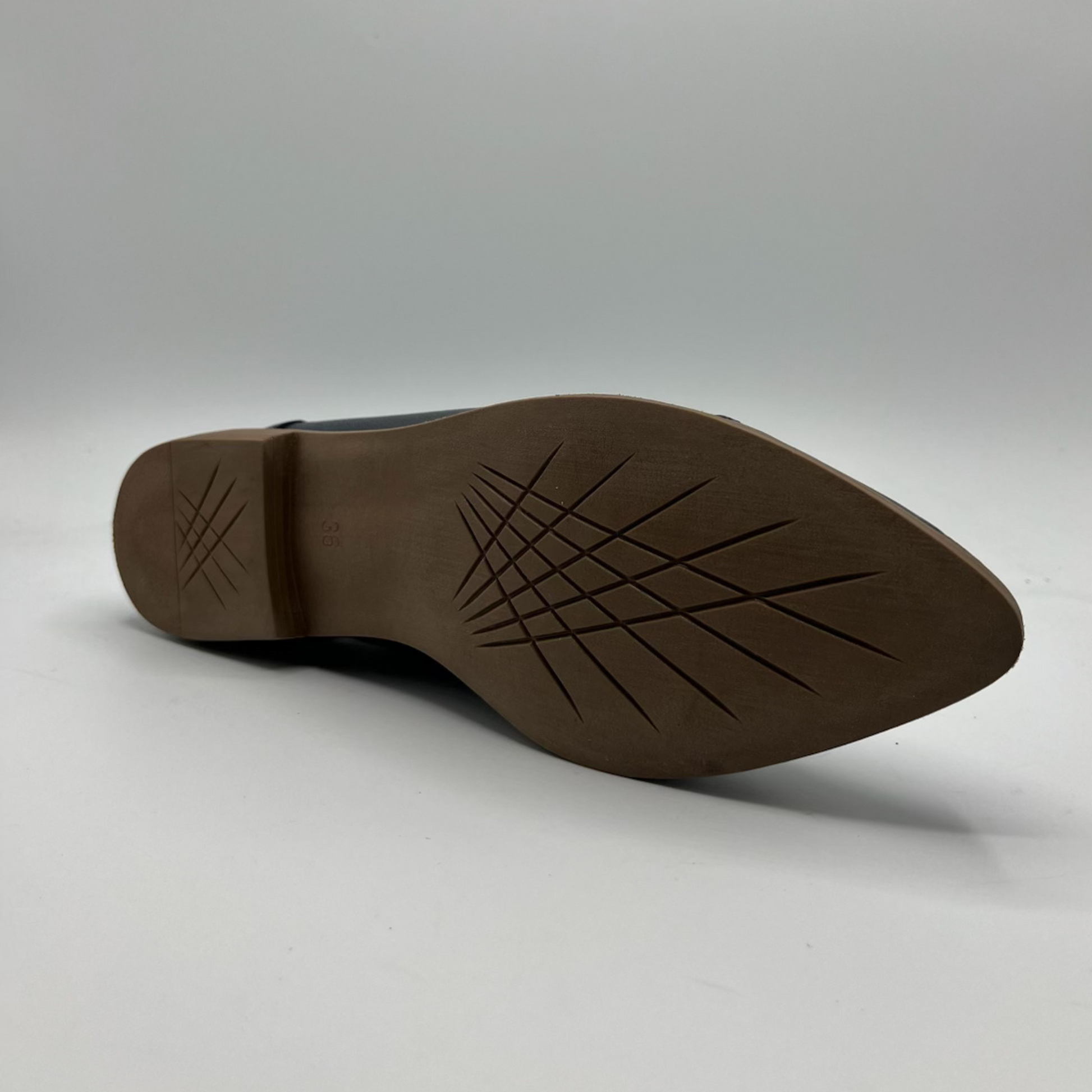 Brown shoe sole on a light gray background