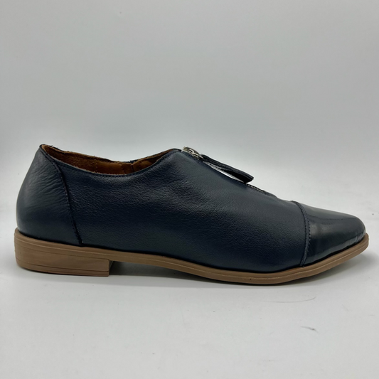 Navy leather shoe with a brown sole on a white background