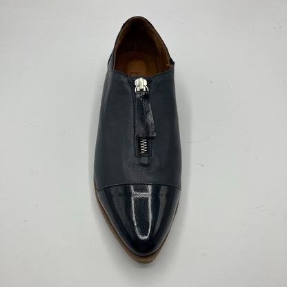 Navy leather shoe with a zipper on a light gray background