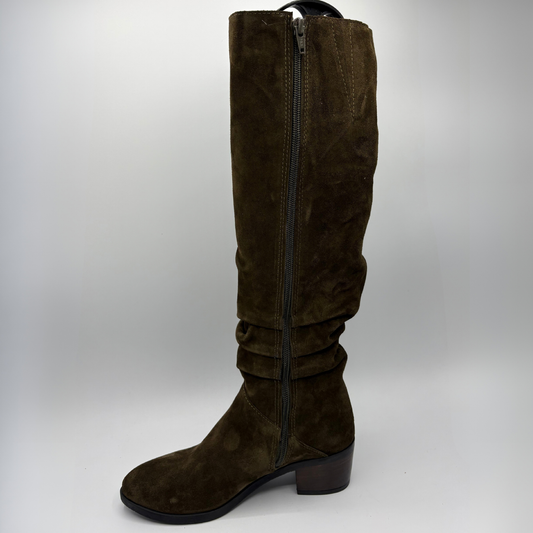 Left view of a brown suede tall boot with a slouchy shaft and short stacked heel
