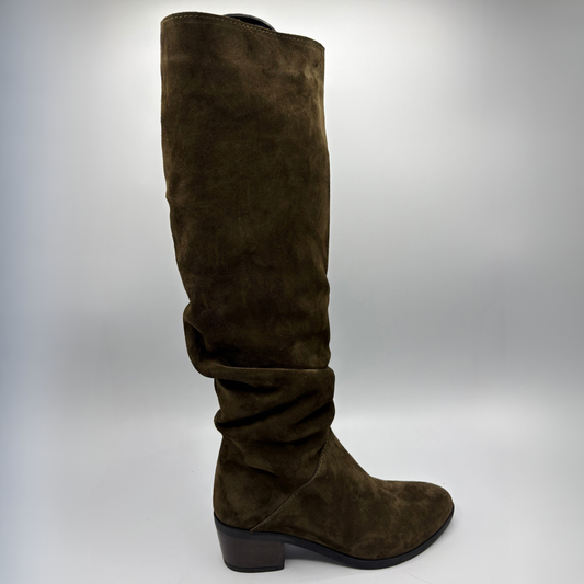 Right facing view of a brown suede tall boot with a slouchy shaft and short stacked heel