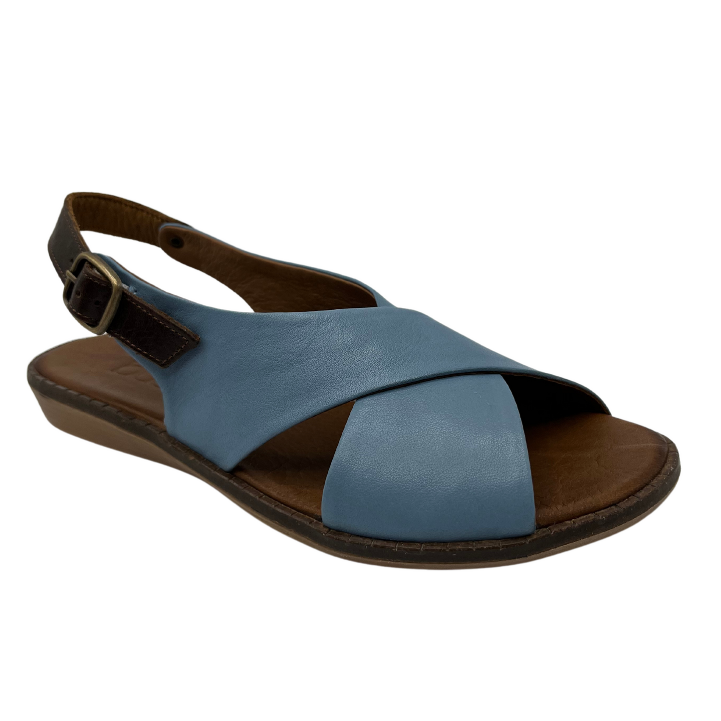 45 degree angled view of light blue leather sandal with cross strap design, slight wedge heel and brown slingback strap