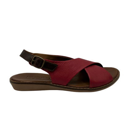 Right facing view of red leather sandal with cross strap design, slight wedge heel and brown slingback strap