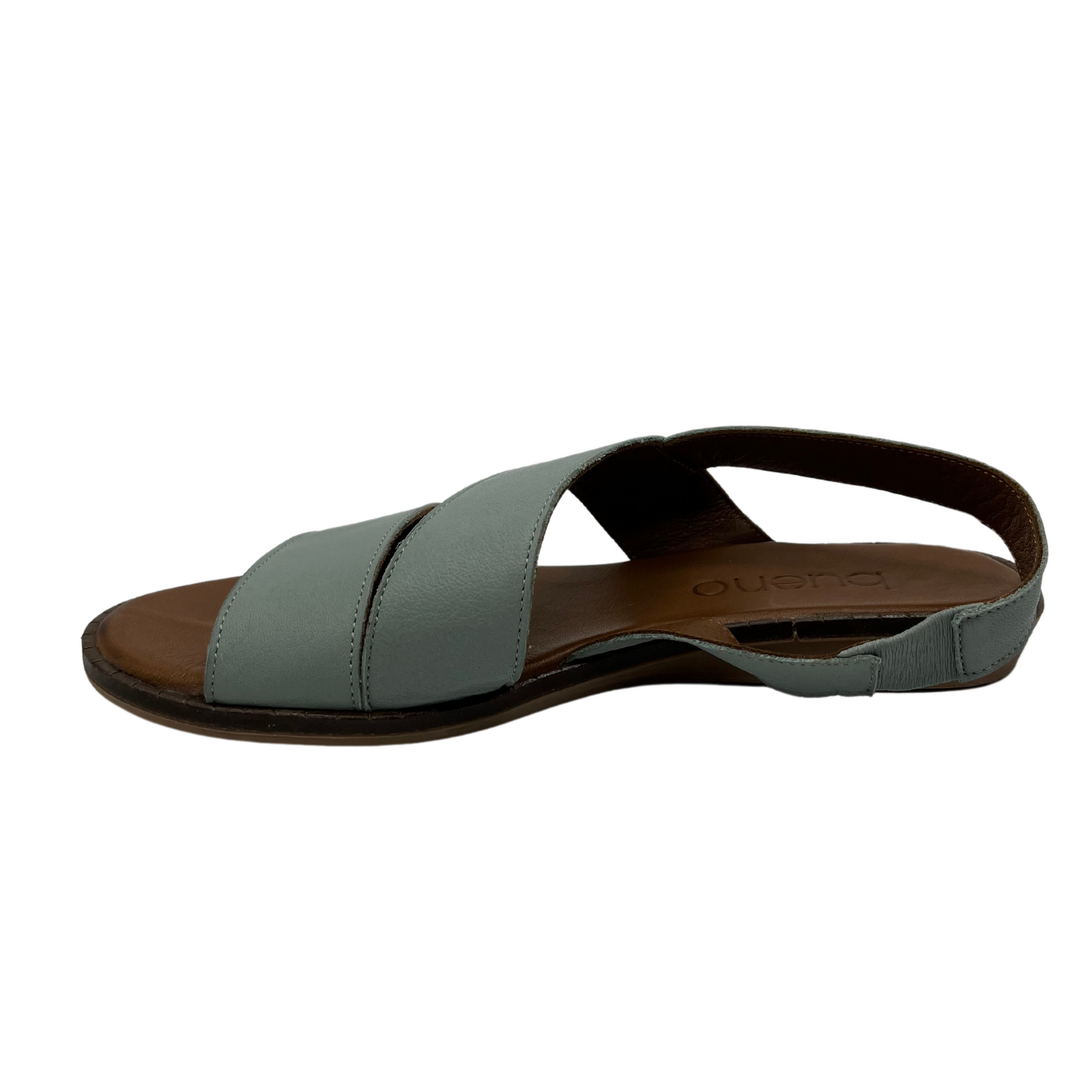 Left facing view of pale green leather sandal with slight wedge heel, rounded tow and slingback strap