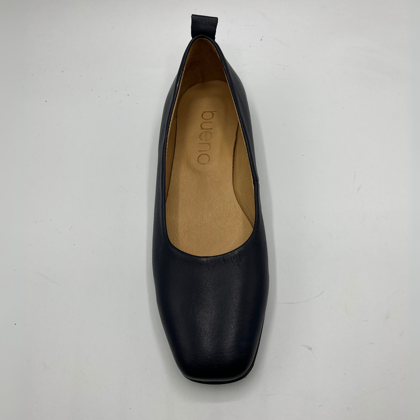 Navy  shoe with tan insole on a white background