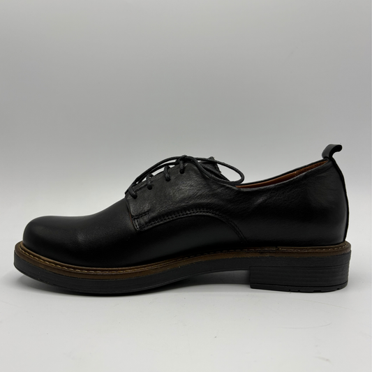 A single black leather lace-up shoe with a low stacked heel and a brown welt, shown in profile against a light gray background.