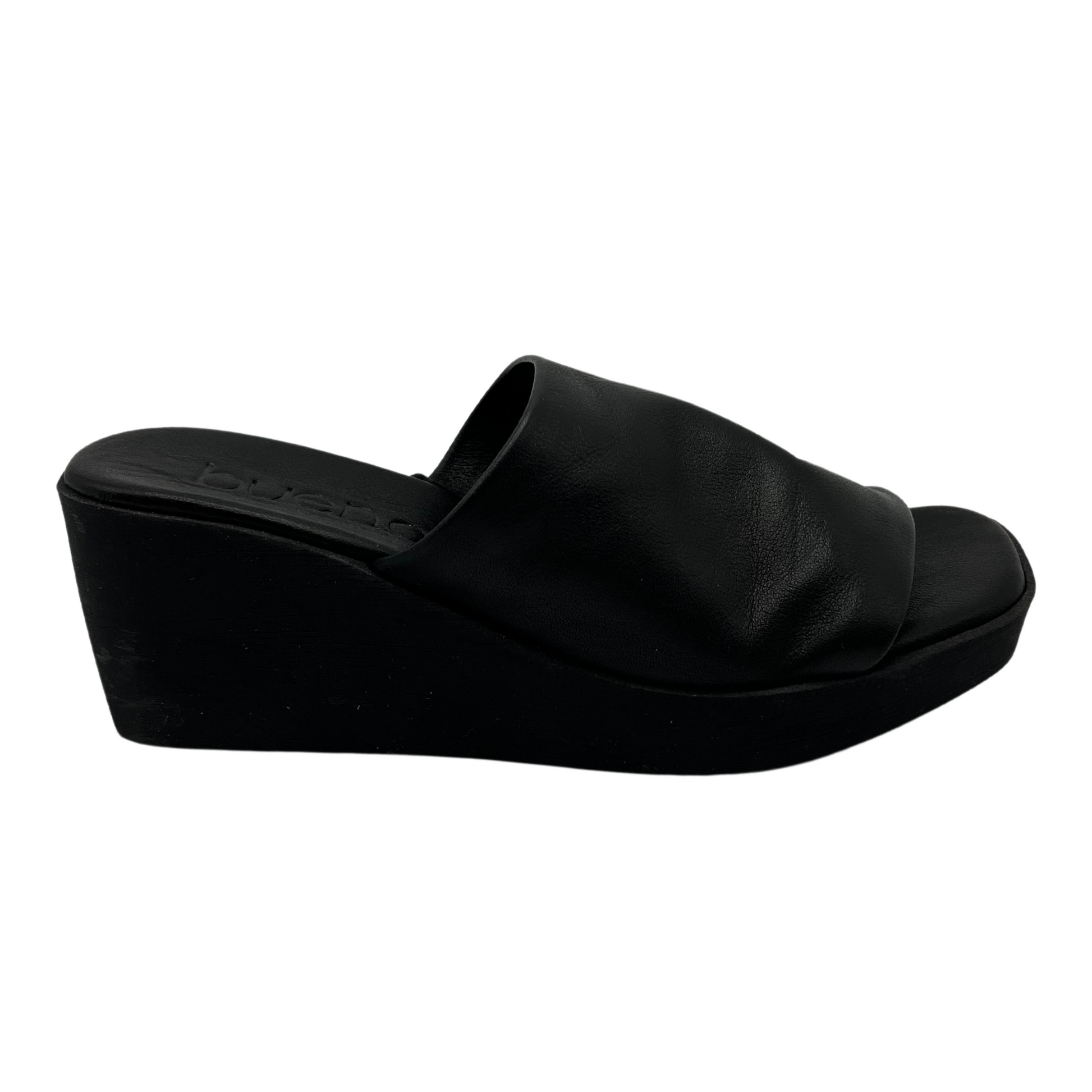 Right facing view of black leather wedge sandal with square toe and black outsole