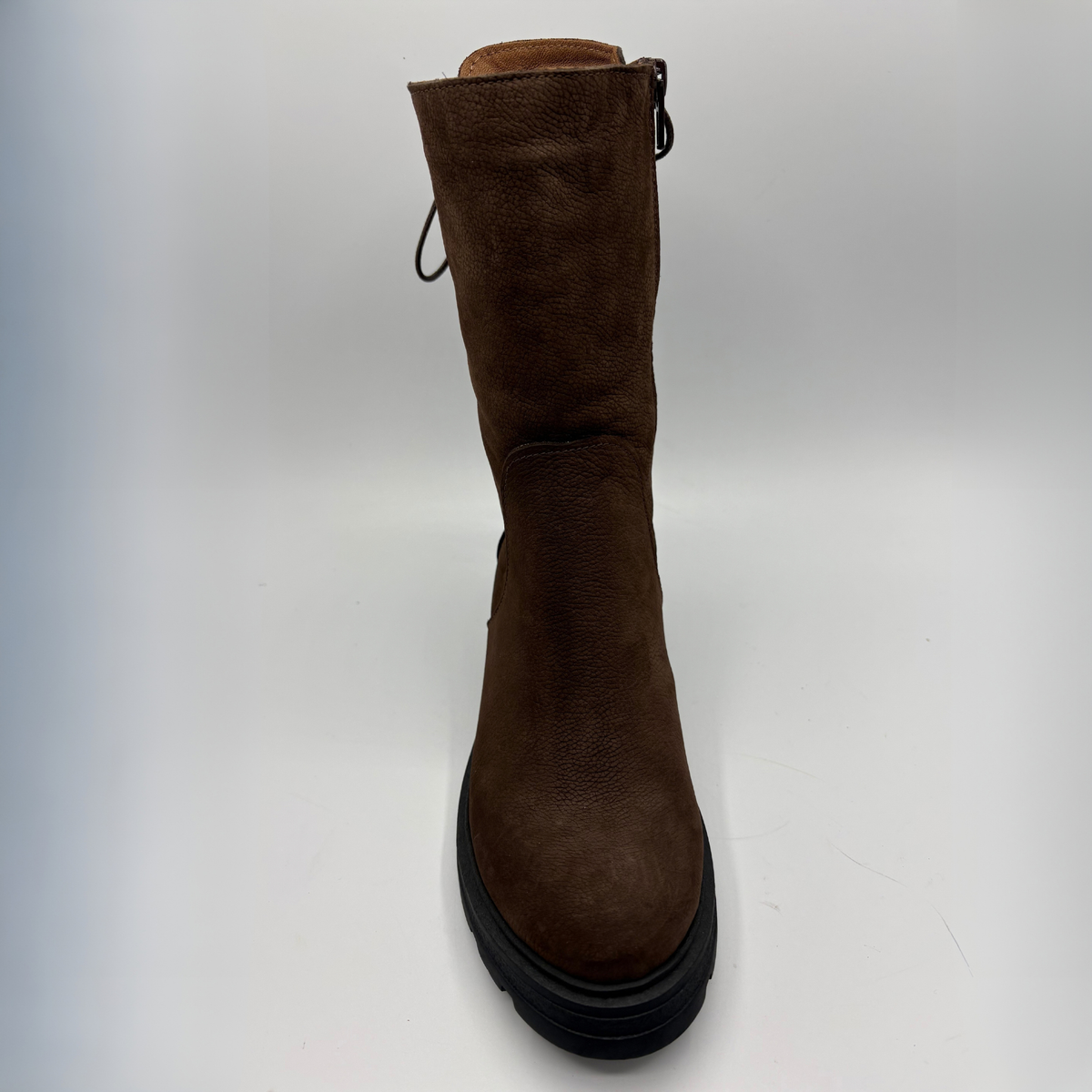 A brown suede mid-calf boot with a black platform sole, shown from a front-facing perspective on a light gray background.