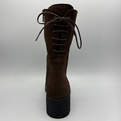 A dark brown suede lace-up boot with a chunky black platform sole, shown from the back against a light gray studio background.