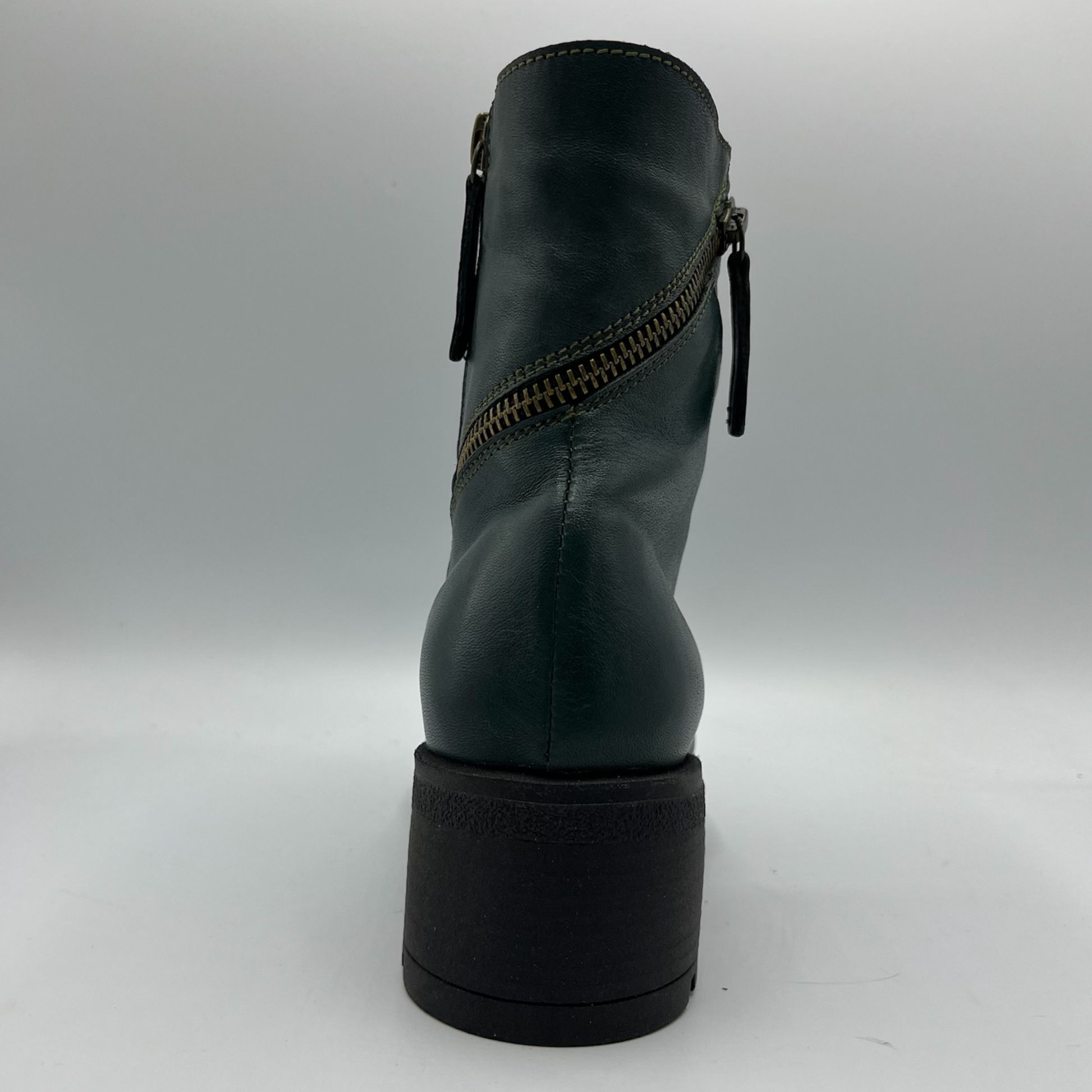 Green leather boot with a zipper on a white background