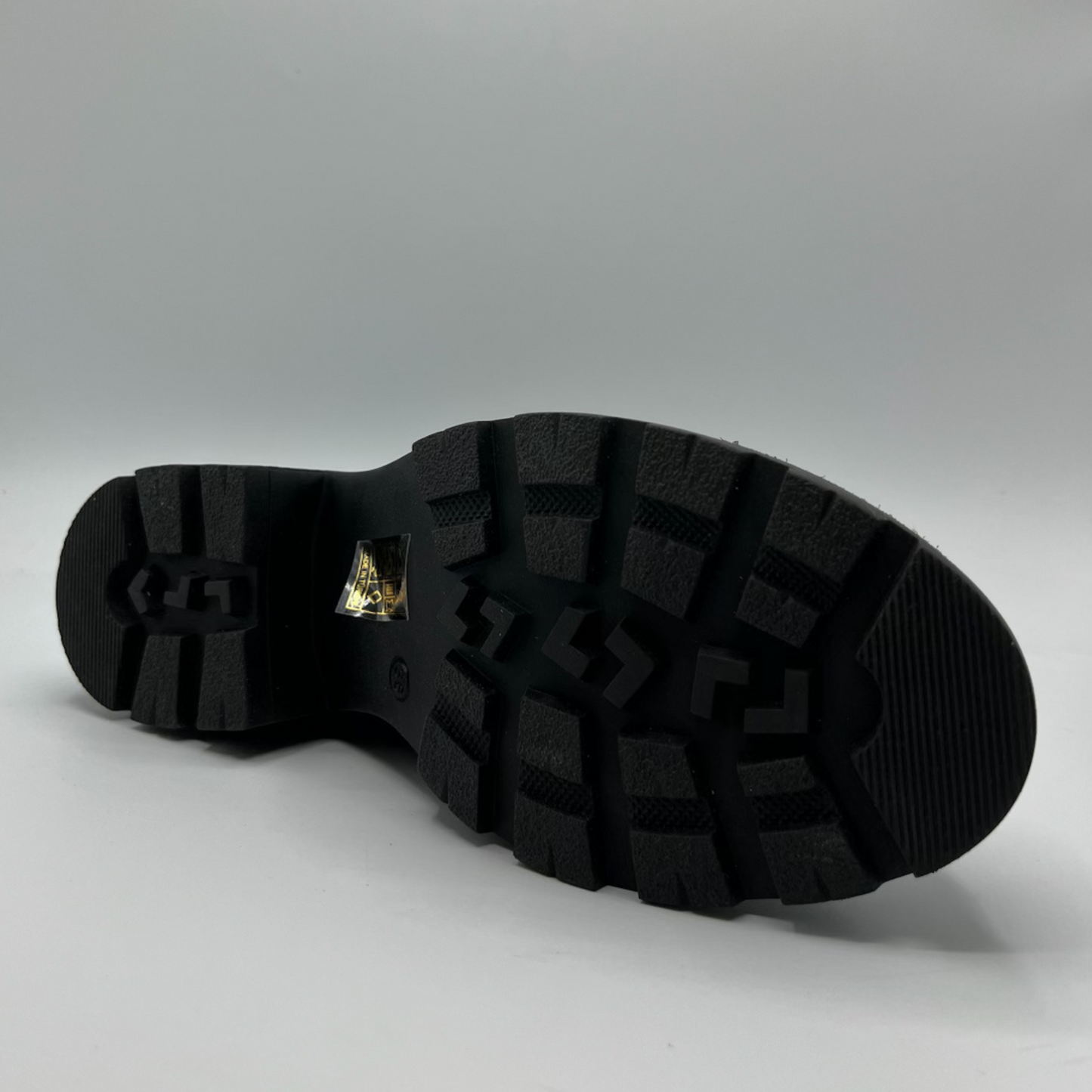 Black sole of a shoe on a gray background