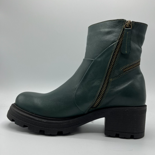 Green leather boot with a zipper on a gray background