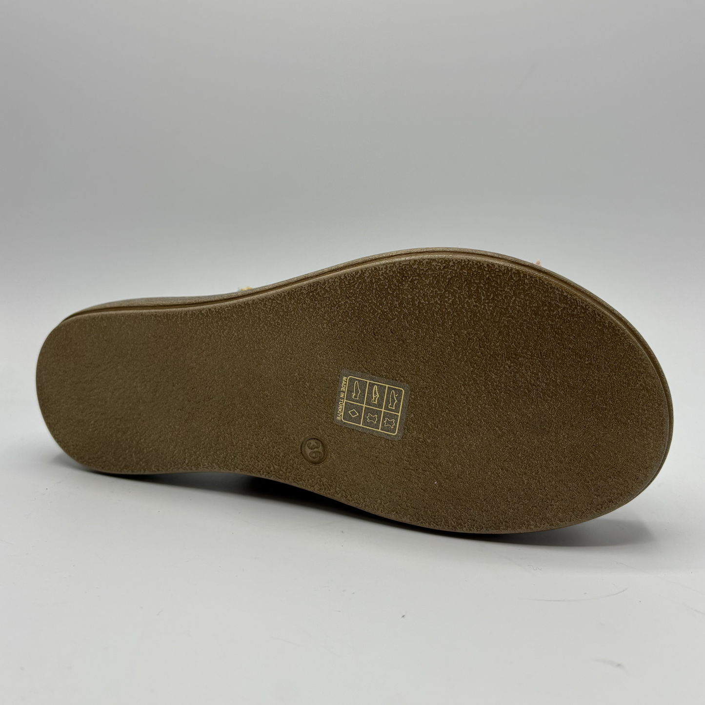 Brown shoe sole with a brand logo on a white background