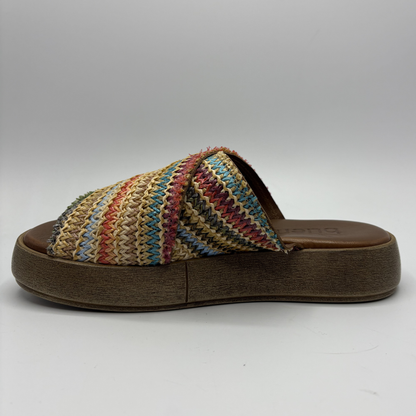 Multicolored striped sandal with a brown sole on a white background