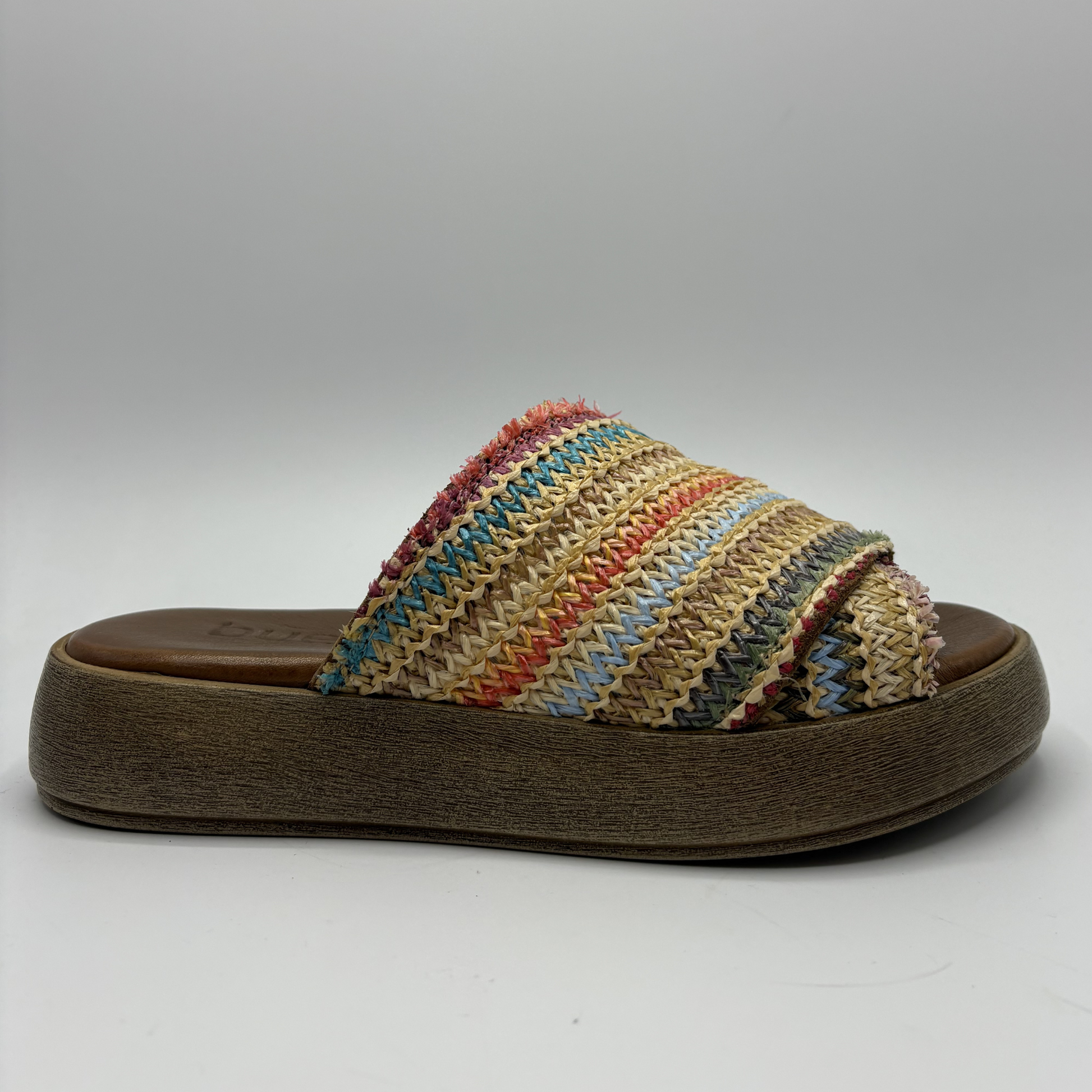 Multicolored woven sandal with a wooden sole on a gray background