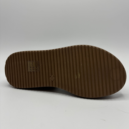 Brown shoe sole with visible brand logo on a white background
