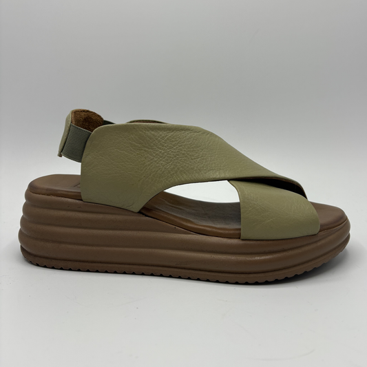 Green sandal with brown sole on a white background