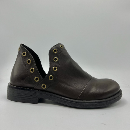 Brown leather shoe with grommet details on a gray background