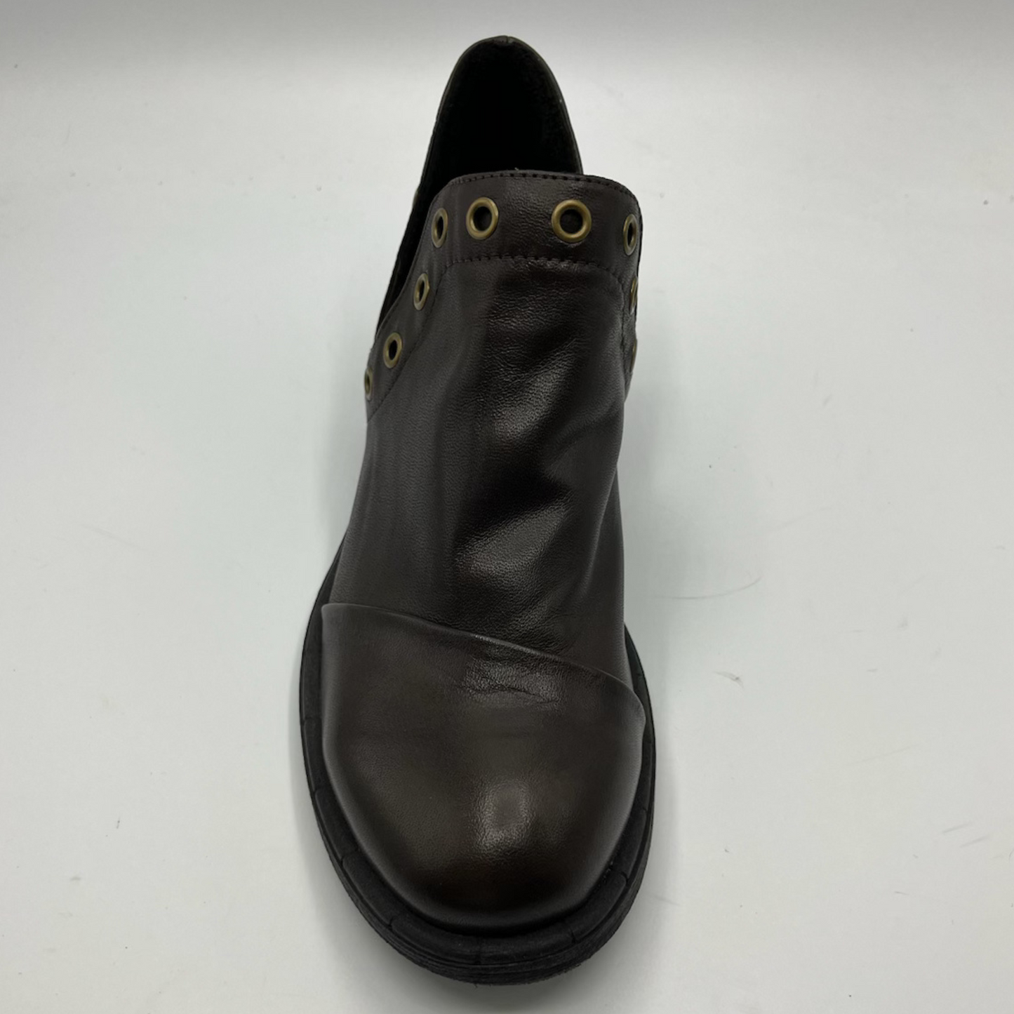 Brown leather boot with grommets on a white background