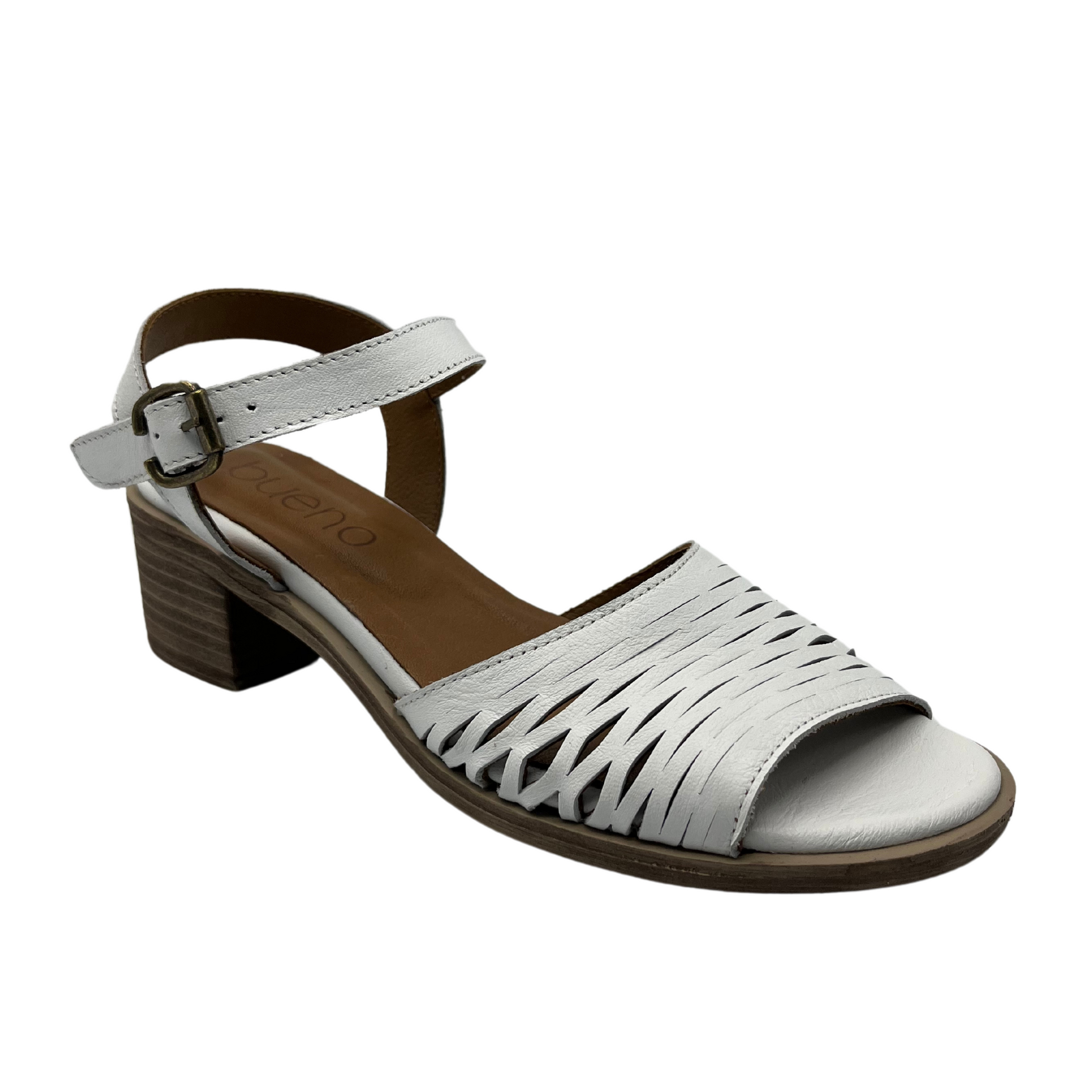 45 degree angled view of white leather sandal with stacked heel and cutout details