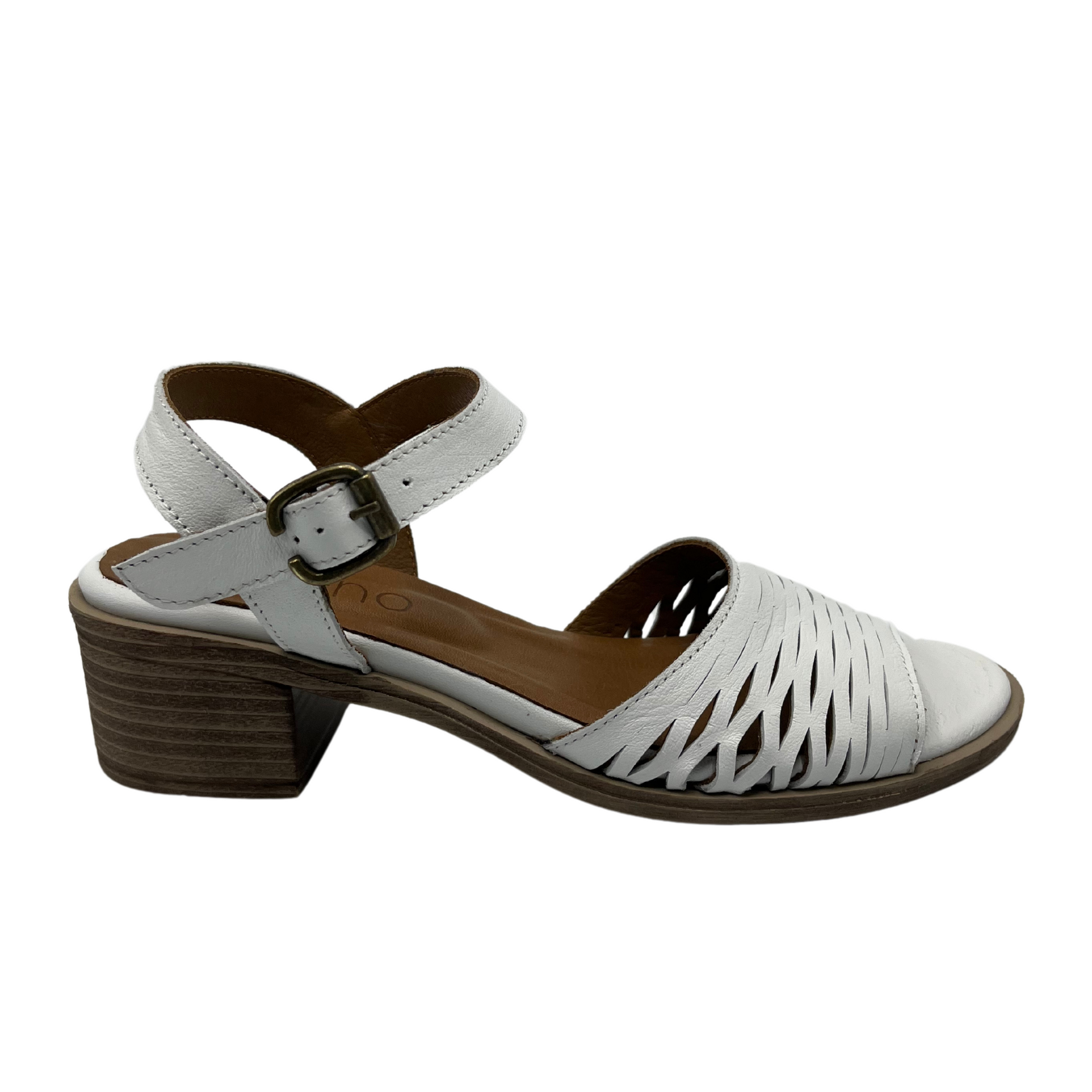 Right facing view of white leather sandal with cutout details and stacked heel