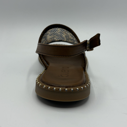 Brown sandal with studded details on a white background