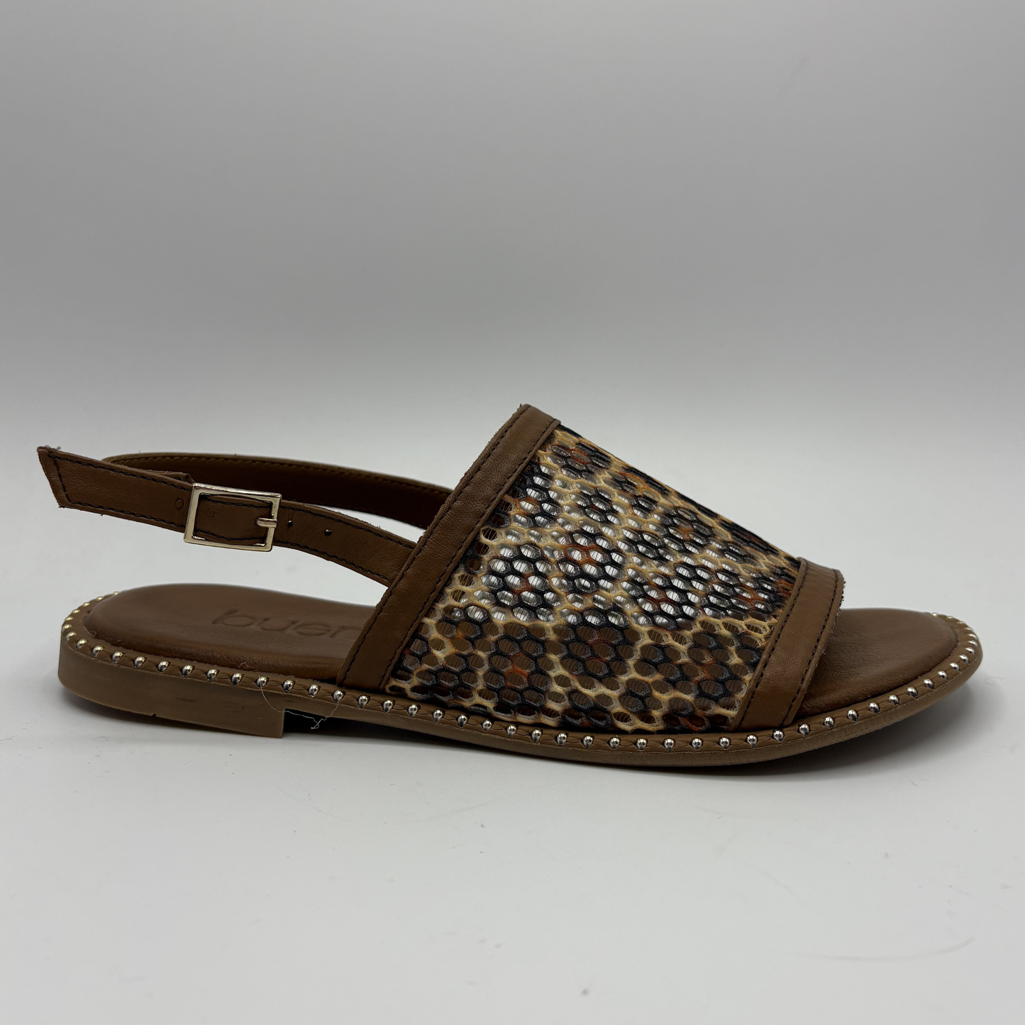 Brown sandal with leopard print strap on a gray background