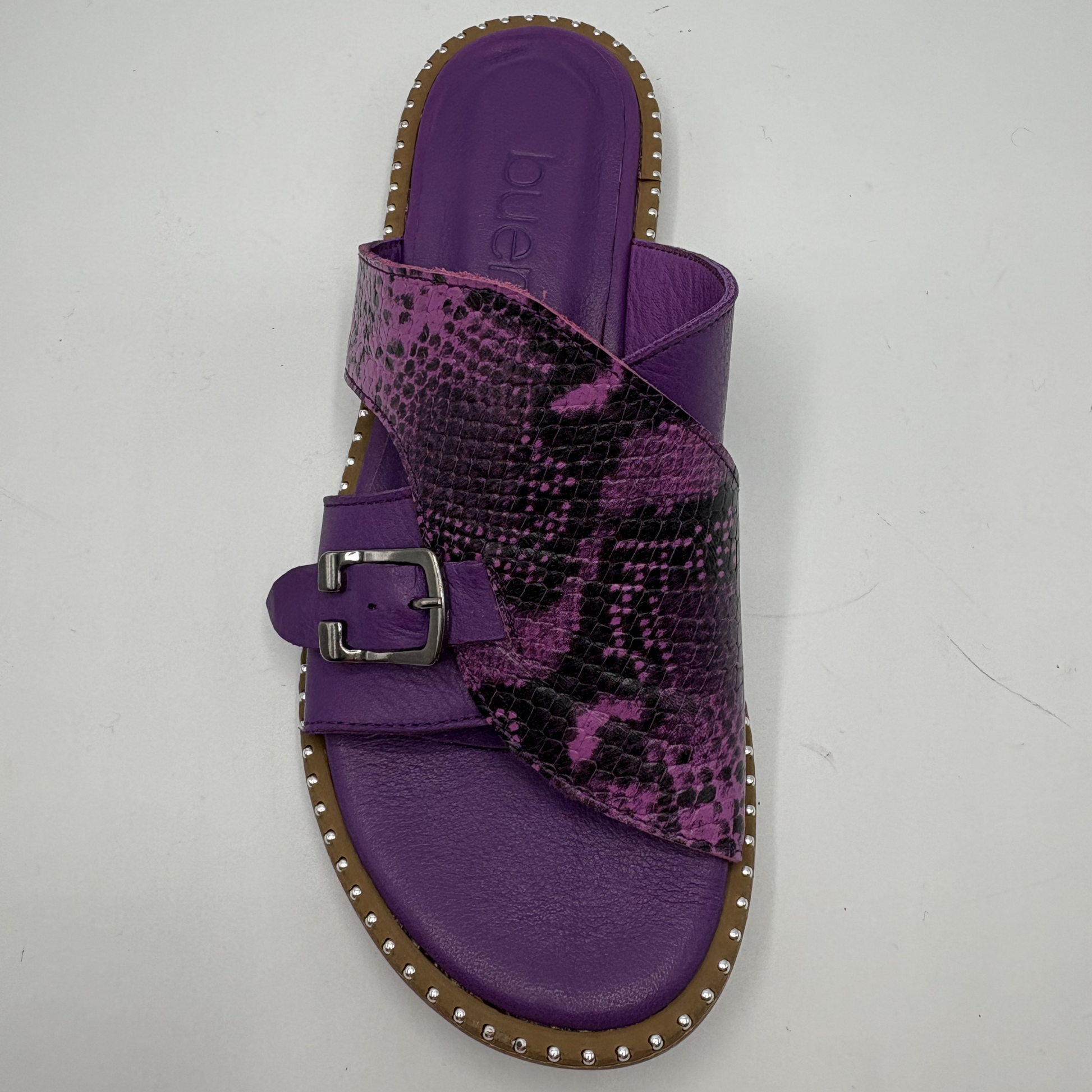 Purple sandal with snake print strap on a white background