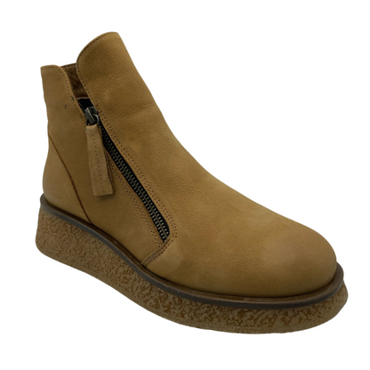 45 degree angled view of desert nubuck short boot with side zipper closure and platform rubber outsole