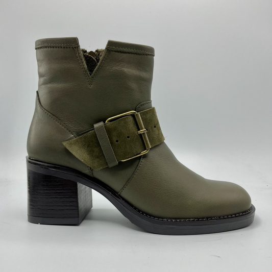 Green ankle boot with a buckle on a white background