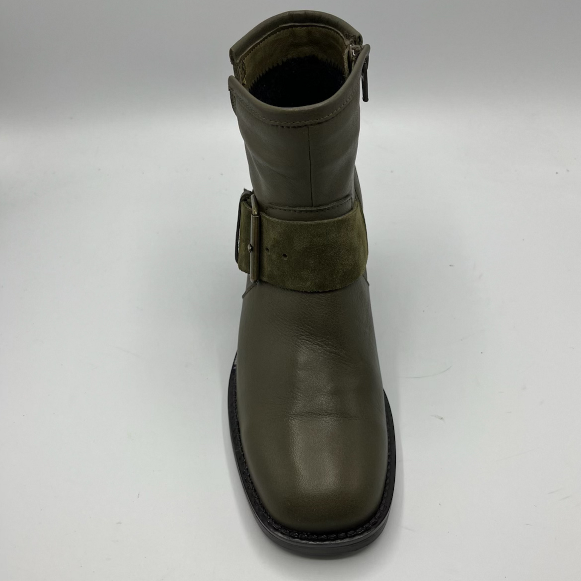 Green leather boot with a buckle on a white background
