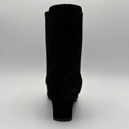 Back view of a black suede ankle boot with a kitten heel and a soft pointed toe