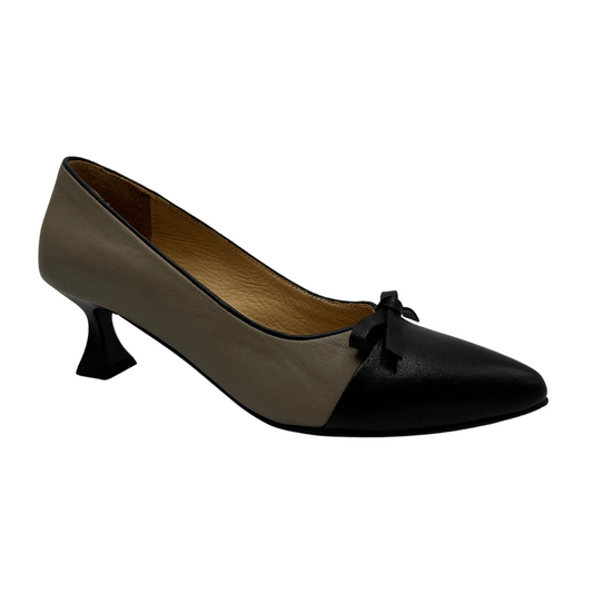 45 degree angled view of grey and black leather pump with flared kitten heel and tiny bow detail.