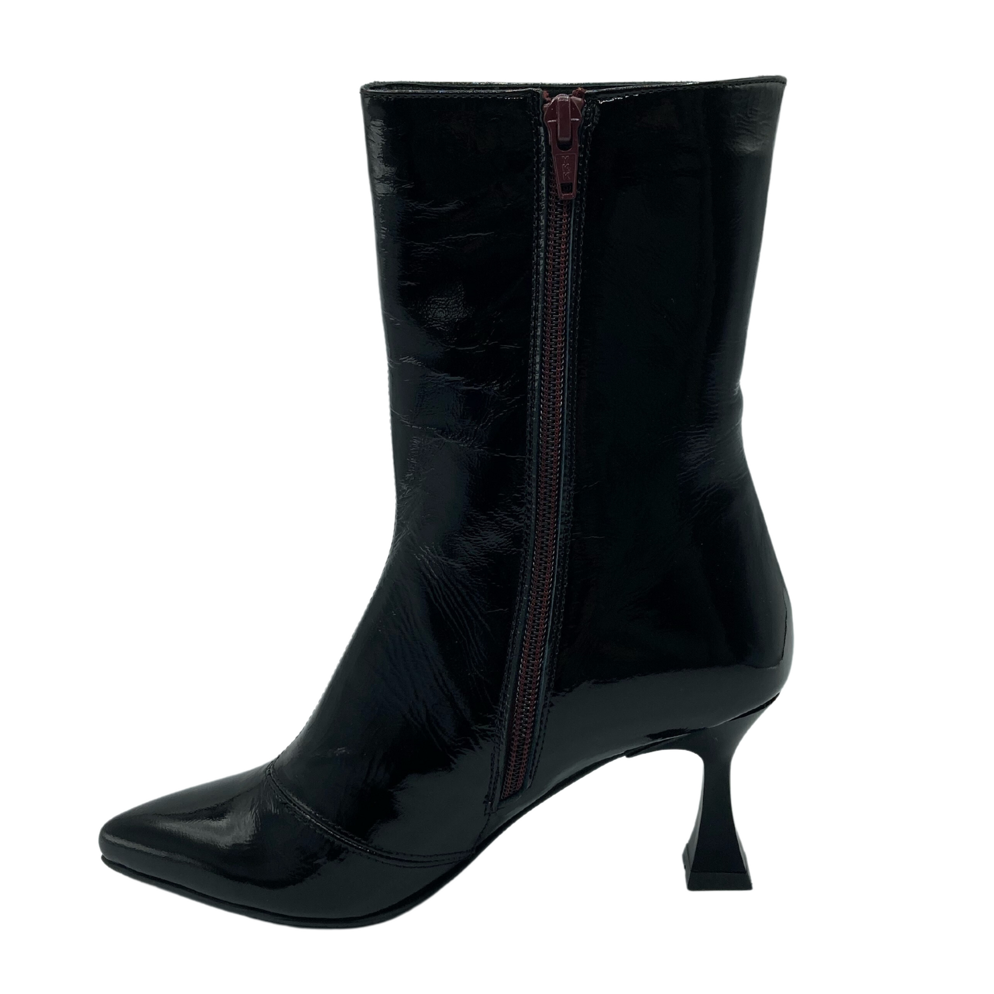 Left facing view of patent leather short boot with side zipper closure, flared heel and pointed toe