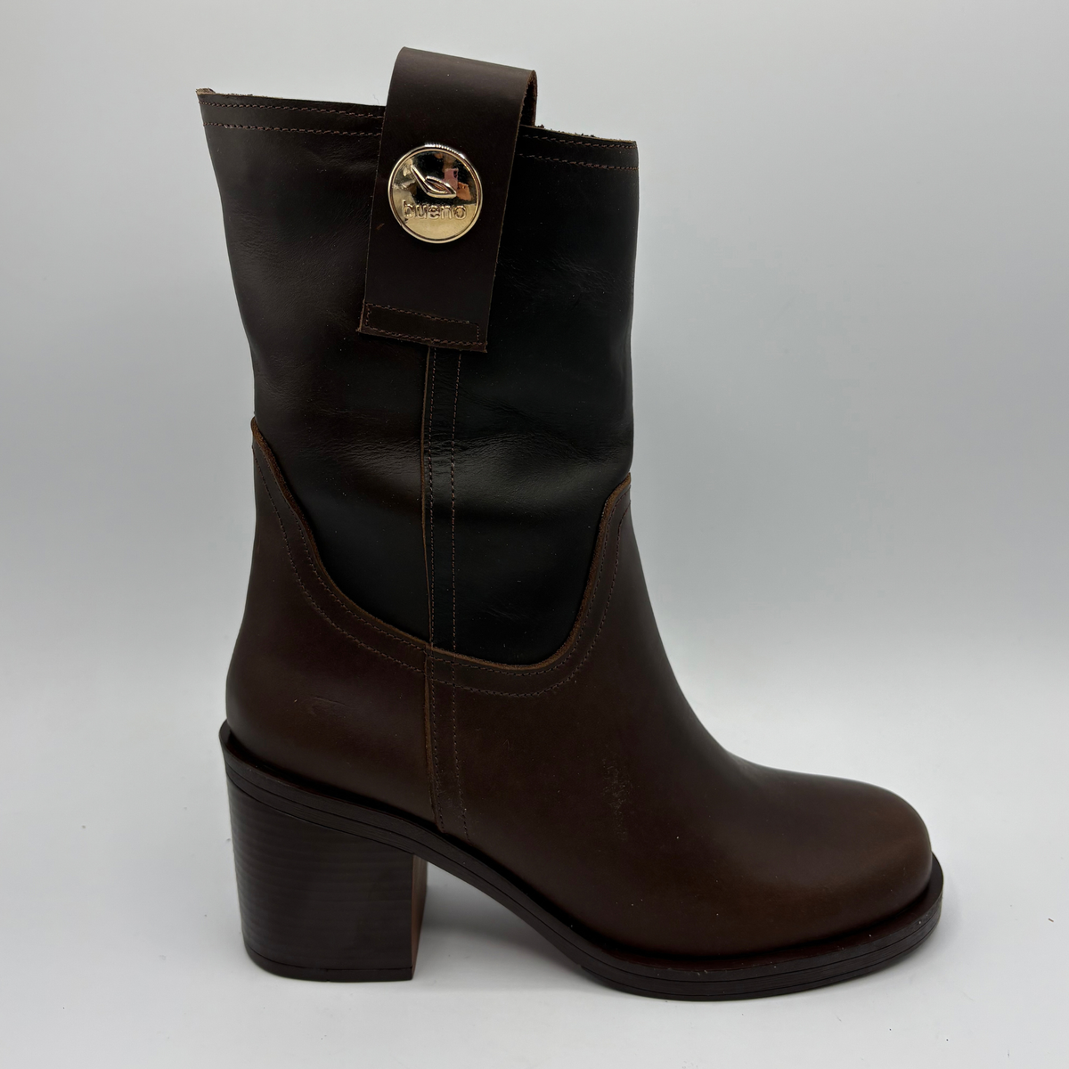 Right facing view of a brown leather short boot with a stacked heel and gold button accent