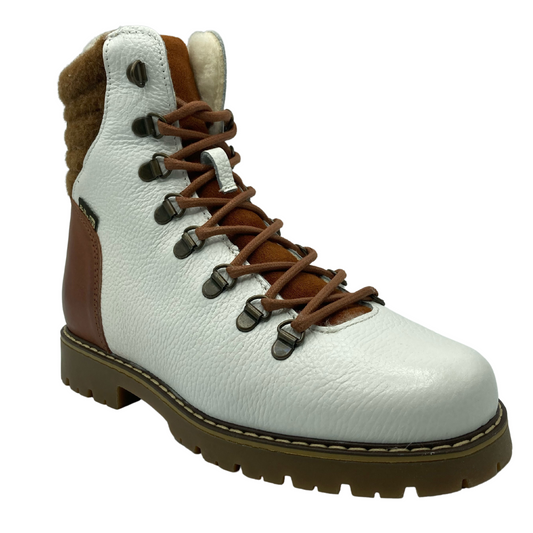 45 degree angled view of white and brown leather boot with brown laces and rubber outsole