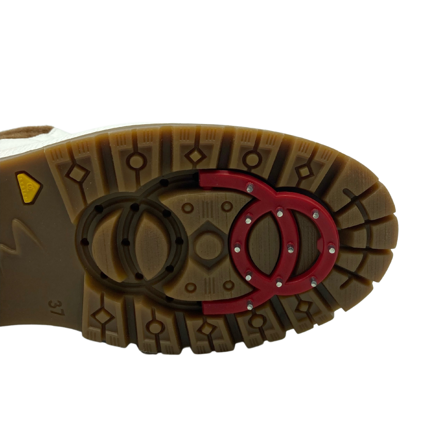 Close up view of rubber outsole with retractable spikes locked in place
