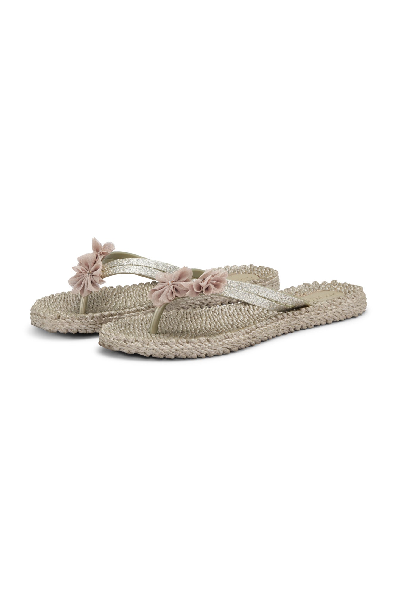 Pair of light-colored sandals with floral straps on a white background