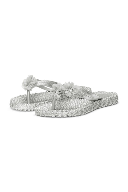 Profile view of a pretty flip flop in silver/grey with matching synthetic floral detail. Shop ILSE JACOBSEN shoes at waterlilyshoes.com