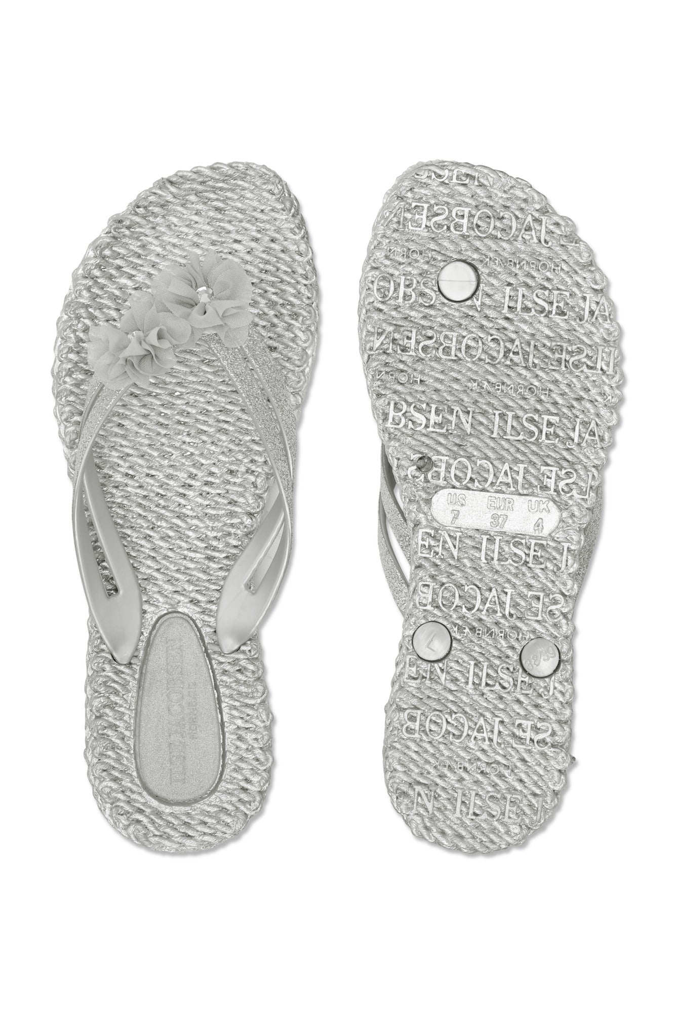 Silver flip flops with pretty synthetic flowers in matching colour. Cheerful 18F Waterlilyshoes.com