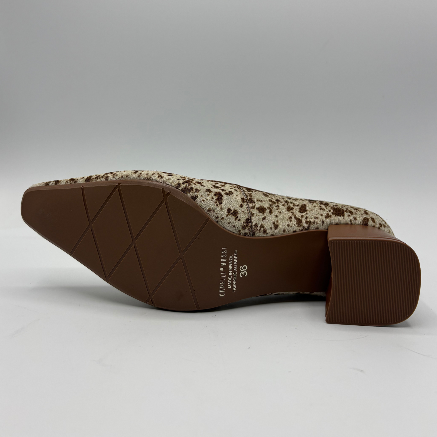 A single women's pointed-toe heeled shoe shown from the side, revealing a brown textured sole and heel with a beige and brown speckled upper, on a light gray studio background.