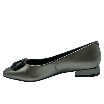 Left facing view of silver ballet flat with black buckle detail on the toe
